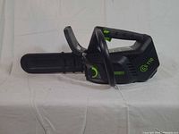 Left side profile showing full chainsaw with bar cover attached