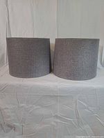 Front view of both gray drum lampshades