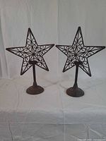 Full view of pair of star candle holders on bases