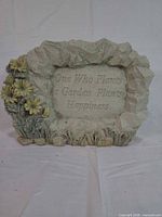 Front view showing inscription and floral accents
