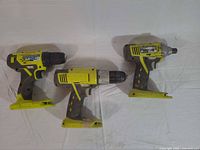 Three Ryobi cordless tools laid out side by side showing overall appearance