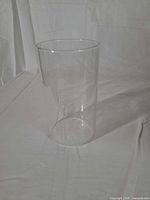 Single clear cylindrical vase upright on white background