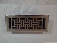 Top view of register showing brushed nickel geometric grille