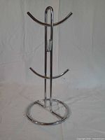Front view of chrome mug tree showing six arms and round base