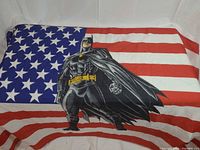 Full flag laid flat showing stars, stripes, Batman graphic