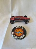 Side view of red Shelby Turbine car with button foreground