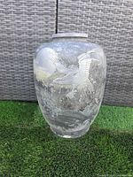 Full view of cast metal urn showing eagle, waves and moon relief