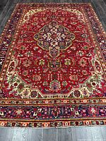 Full view of entire Tabriz rug showing design and borders