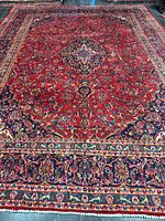 Full view of the red Kashan rug showing medallion and borders