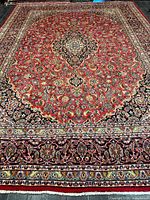 Full view of Persian rug showing entire pattern and borders