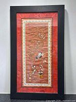 Full view of framed embroidered panel