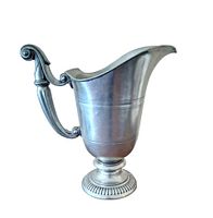Left front view of pewter pitcher against white background