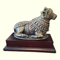 Left-front view of brass Nandi bull on wood base