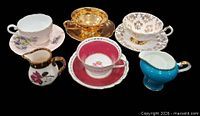 Group shot of 4 teacup/saucer sets and 2 creamers