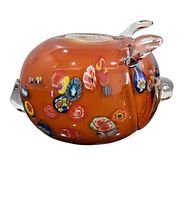 Side profile showing orange body, millefiori inlays, clear ears, tail, polished base