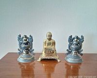 Full set showing Buddha incense burner flanked by two candle holders