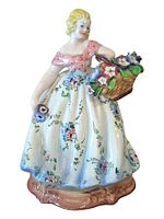 Front view of Sebelin ceramic lady figurine showing dress, basket, overall condition