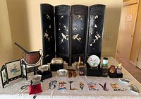 Overall lot showing folding screen and assorted Asian decor on table