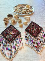 Lot overview showing 2 wall hangings, shells and silverplate tray