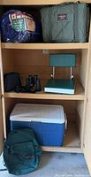 Cabinet view with all six camping items