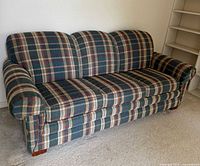 Front angled view of plaid La-Z-Boy sleeper sofa