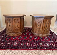 Pair of octagonal wood end tables on red Bokhara rug
