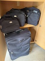 All three luggage pieces inside cabinet