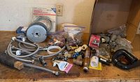 Bench view of entire lot showing hoses, fittings, P-trap, valves and hardware