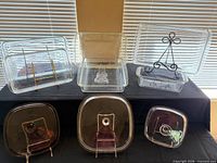 Group shot of five clear baking dishes, three lids and stands