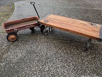 Wagon and bench side by side on pavement
