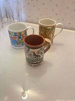 Three mugs grouped: Tonala front, Dunoon and Japan mugs rear