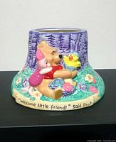 Front view showing Pooh, Piglet, chick and inscription on rim