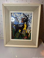 Front view of framed latch hook deer art