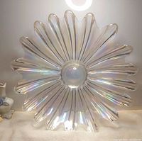 Front view of iridescent glass plate showing full sunburst flower design