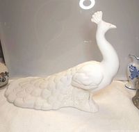 Front angled view showing full figurine and feather detail