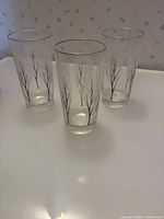 Three tree branch print glasses standing upright