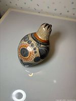 Front angled view of bird figurine showing overall form and painted decoration