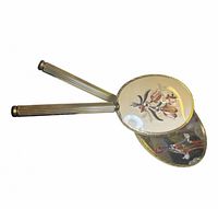 Mirror and brush showing ribbed handles and gold-tone construction