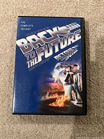Front cover of DVD case showing Back to the Future The Complete Trilogy artwork