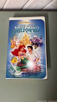 Front of clamshell case featuring The Little Mermaid artwork