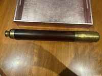 Spyglass collapsed beside tray showing full length and material contrast