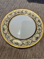 Front of plate showing ornate gold and green border and white center
