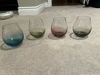 Set of four crackle design stemless wine glasses in teal, green, mauve, grey