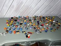 Wide shot of entire lot of Disney Doorables figurines spread on table