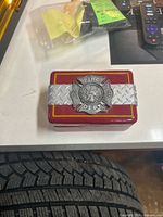 Keepsake box closed, showing Fire Dept emblem and diamond-plate band