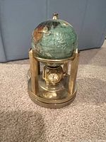 Gemstone globe on brass stand with clock