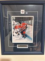 Frontal view of framed, signed Henri Richard photograph with logo and plaque visible