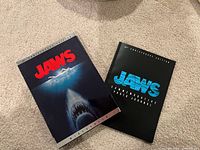 Front view showing Jaws video collectors box and Jaws anniversary hardcover book side by side