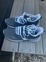 Side view of both shoes showing mesh uppers, laces, midsoles