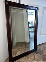 Front view of rectangular wood-framed mirror